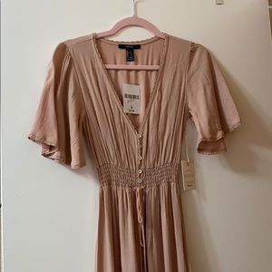 Nude colored long dress.